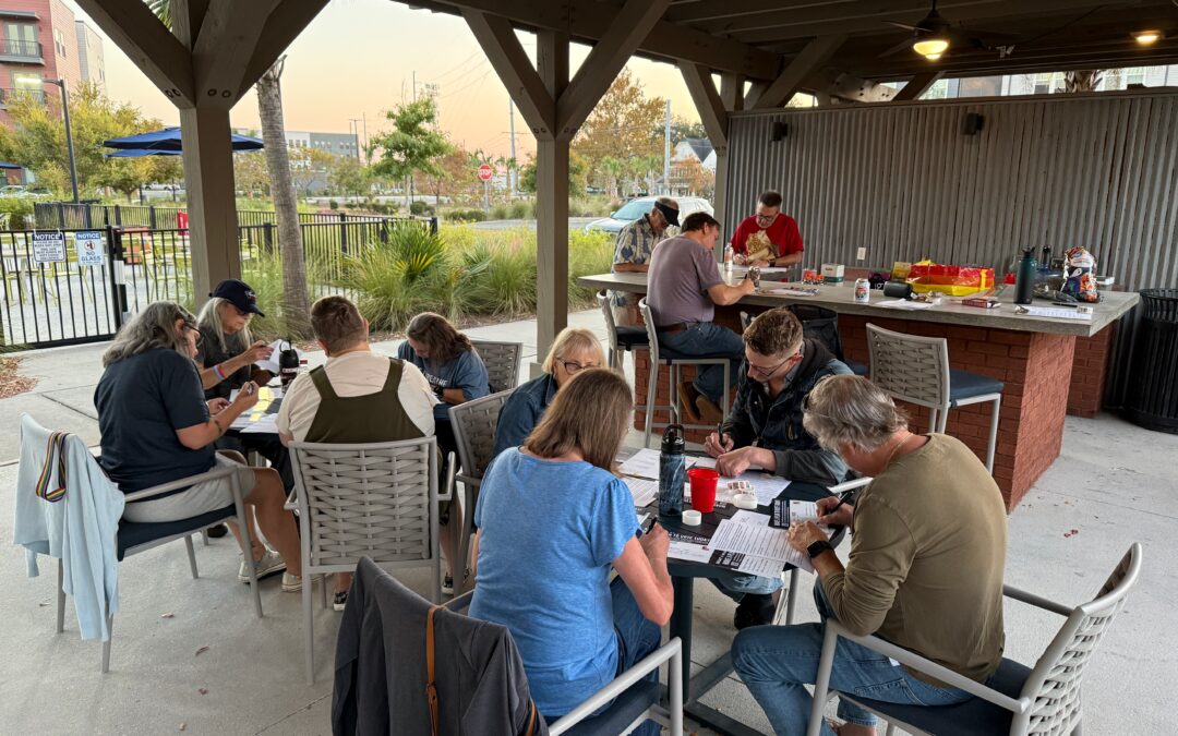 Photo of SHL members writing postcards at party