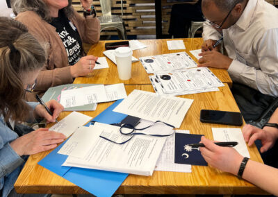 Photo of SHL members filling out postcards