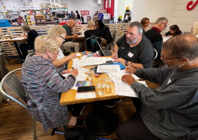 Photo of SHL members filling out postcards